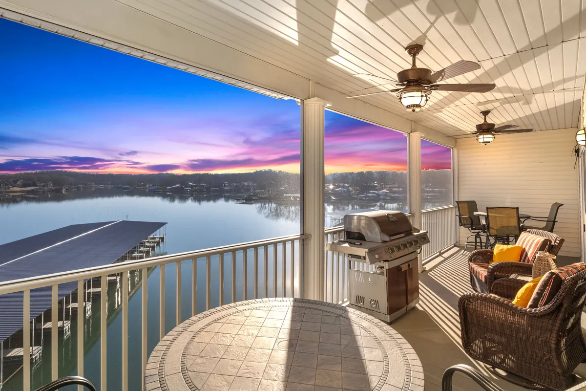 This image shows an inviting outdoor seating area with a grill, all set against a stunning sunset sky and open lake view. The space is perfect for outdoor dining, barbecues, and social gatherings while enjoying the tranquil natural surroundings.